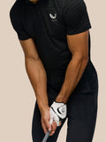 Male model wearing Golf Pinnacle Pique Stripe Polo in black with alloy stripes
