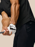 Back view of a man in the black Pinnacle Pique Stripe Polo showing all over stripes and Castore branding on the upper back.