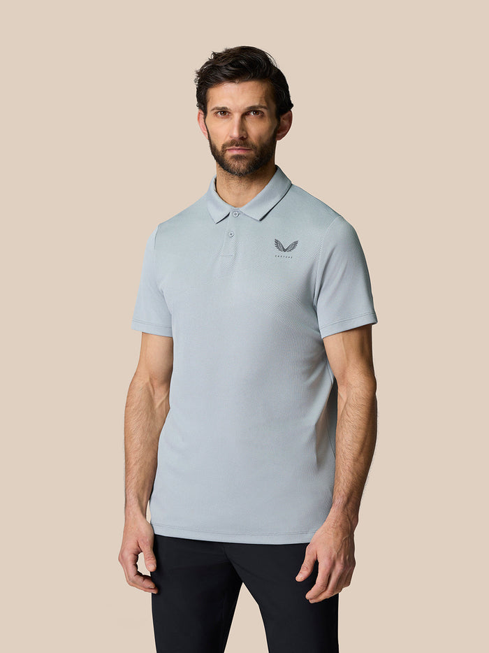 Male model wearing mid grey Golf Pinnacle Polo with short sleeves and breathable knit fabric