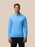 Model wearing cool blue Golf Club Classic 1/4 Zip Top with funnel collar and chest logo.
