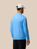 Back view of a man wearing the Golf Club Classic 1/4 Zip Top in Cool Blue with a vertical Castore logo on the back