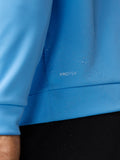 Close-up of blue ProTek fabric with water droplets on the Golf Club Classic Top