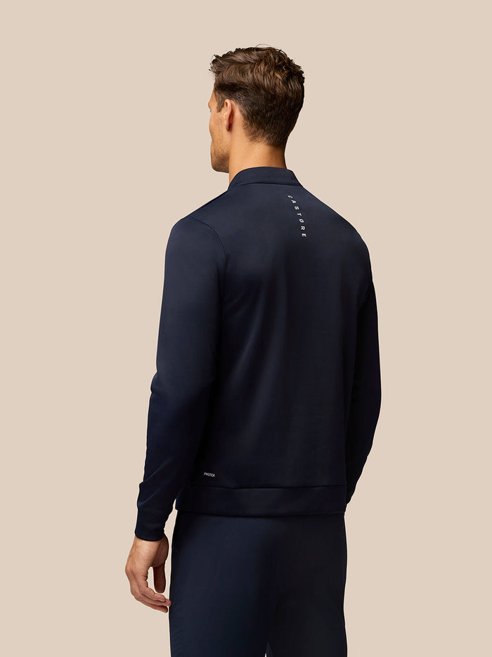 Back view of navy Golf Club Classic 1/4 Zip Top with vertical Castore branding on the upper back