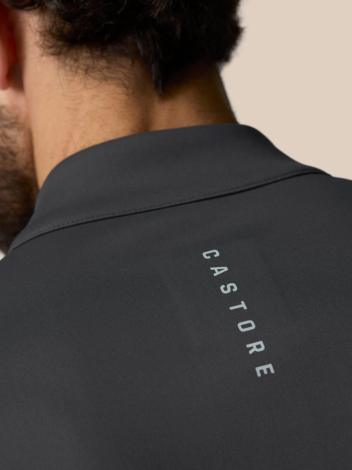Back view of gunmetal Golf Club Classic Quarter Zip Top showing vertical Castore branding along the back.