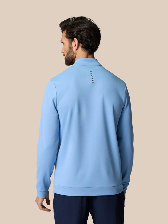 Back view of sky blue Golf Club Classic Quarter Zip Top showing vertical Castore branding on upper back