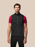 Male model wearing black Pinnacle gilet with stand collar over pink short sleeve shirt on the course