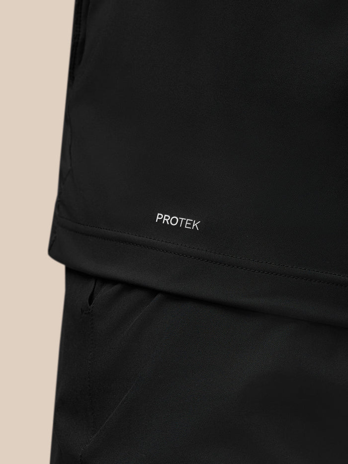 Close-up of Protek branding at the lower back of the black Pinnacle gilet.