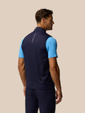 Male model seen from the back in navy Pinnacle gilet with Castore branding on the collar and upper back