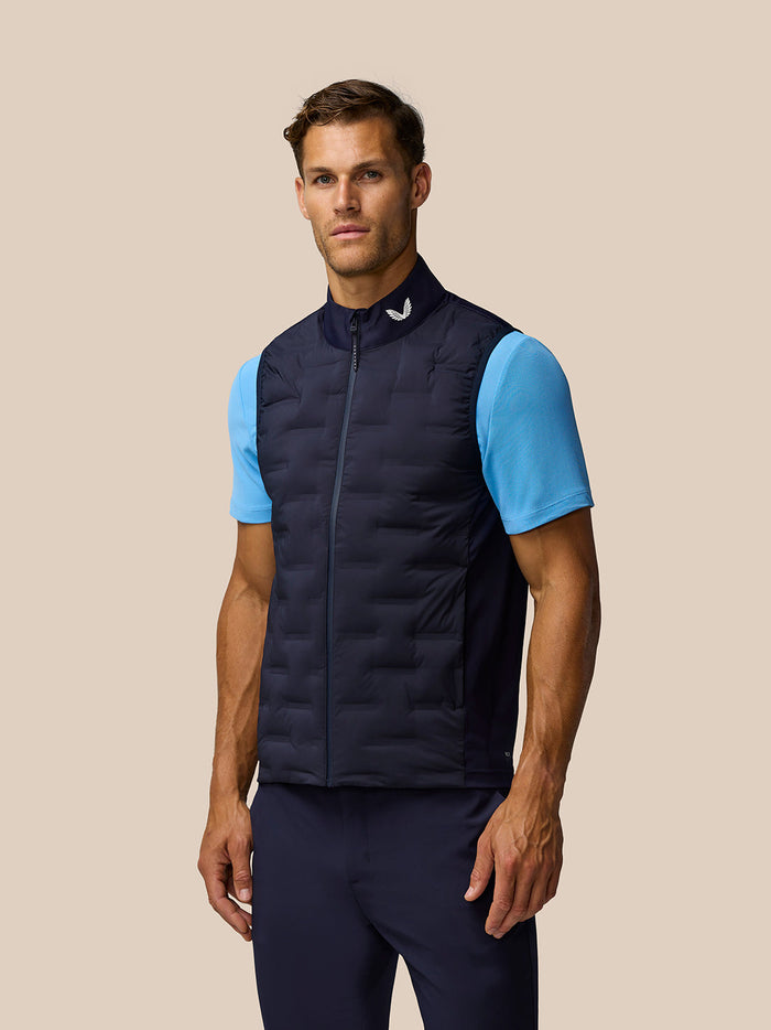 Male model wearing navy Pinnacle Gilet with full zip over blue short sleeve top