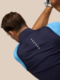 Back view of male model wearing navy Pinnacle Gilet over a blue top with CASTORE branding on the back.