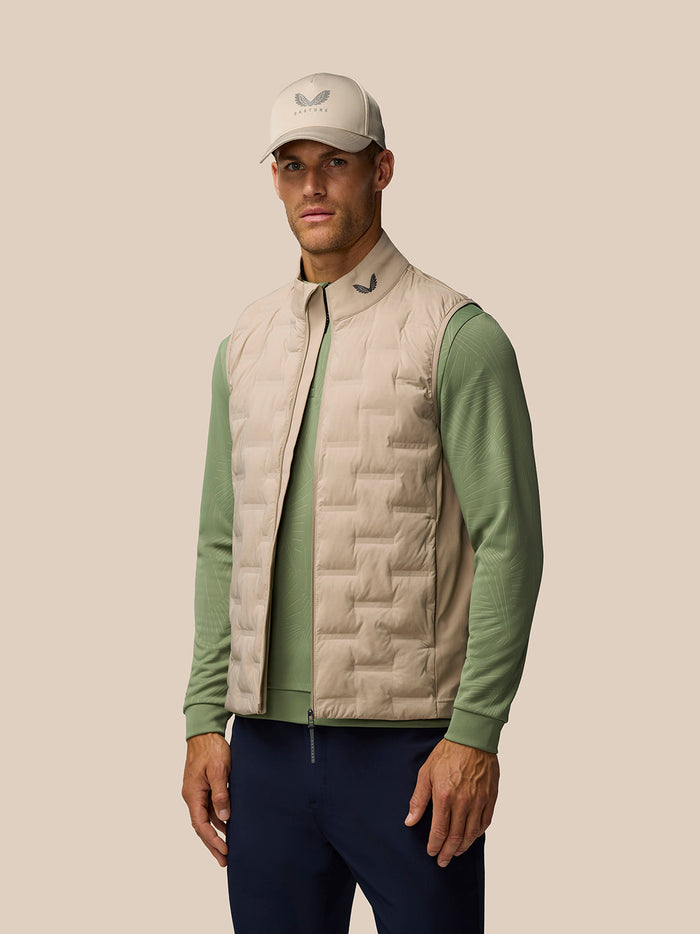 Beige Golf Pinnacle lightweight gilet with quilted front panels and funnel collar on a model.