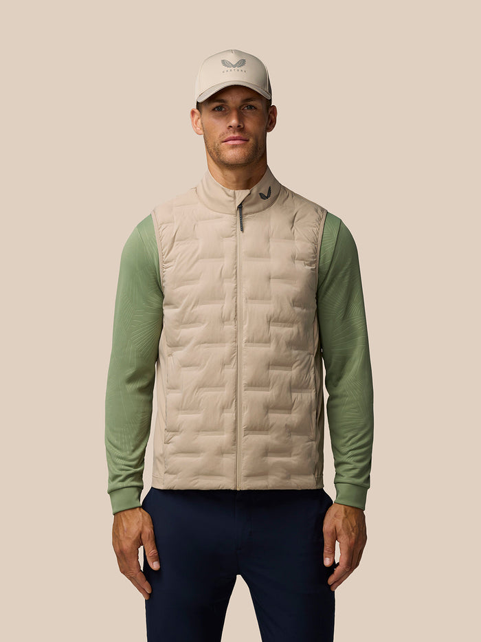 Front view of a male model wearing Mushroom Golf Pinnacle Lightweight Hybrid Gilet with quilted front and funnel collar