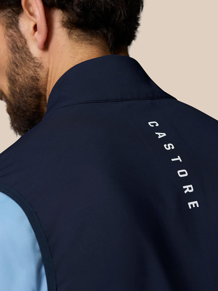 Close up of navy Pinnacle Gilet collar from behind with Castore branding along the back