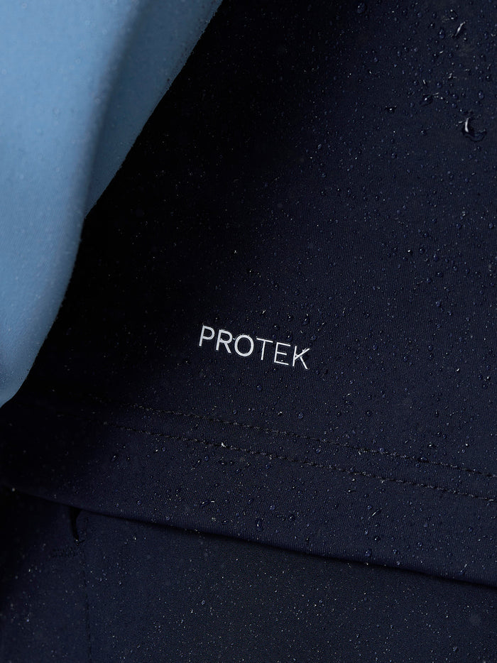 Close up of navy Protek fabric with water droplets and a light blue sleeve