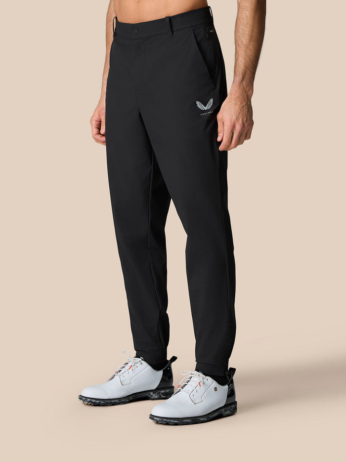 Male model in black golf trousers with side pockets and cuffed hems for a tapered look