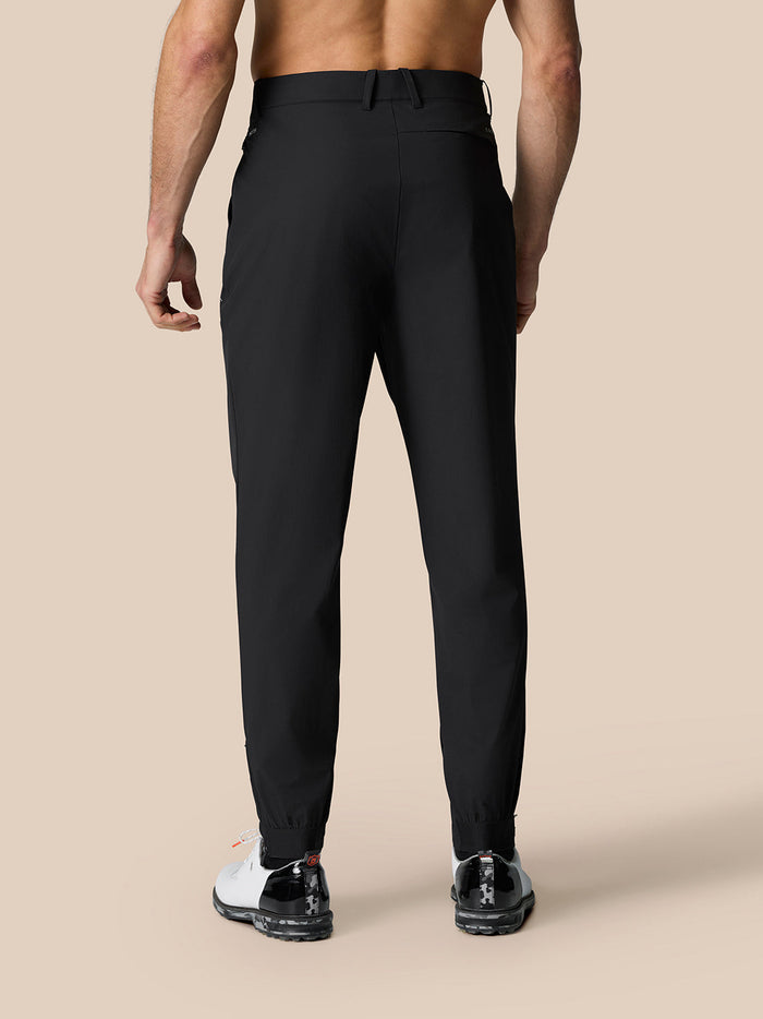 Back view of black golf trousers showing belt loops and elastic cuffs for secure fit