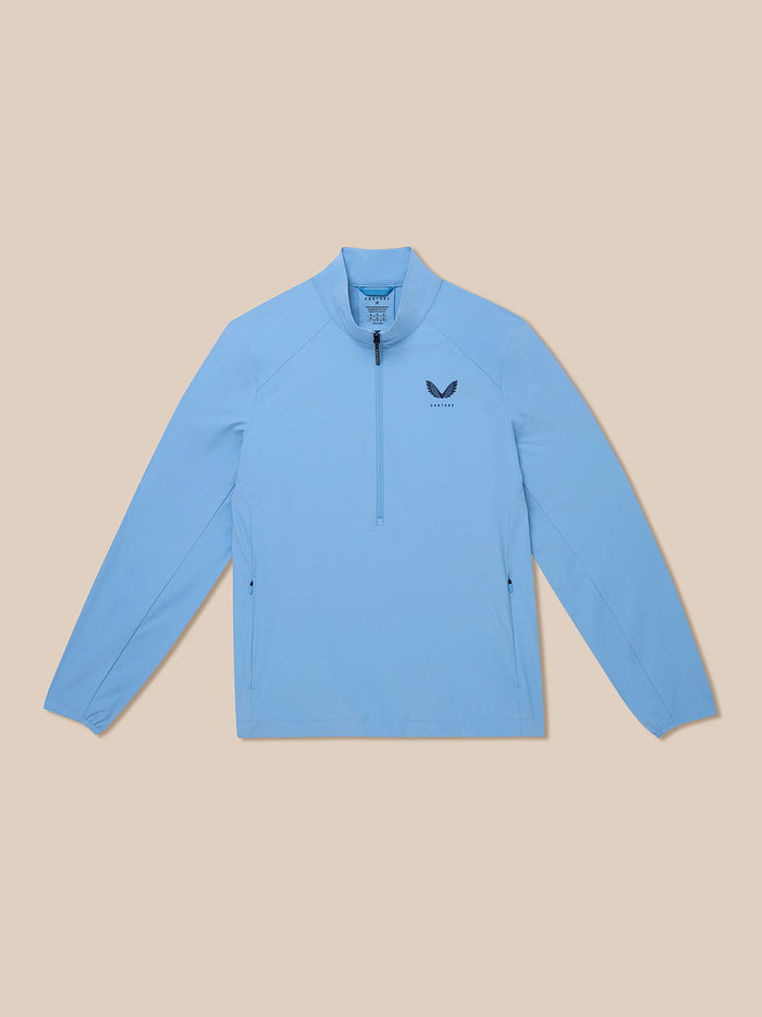 Front view of a sky blue Castore Golf Flex Half Zip Jacket with a standing collar and chest logo.