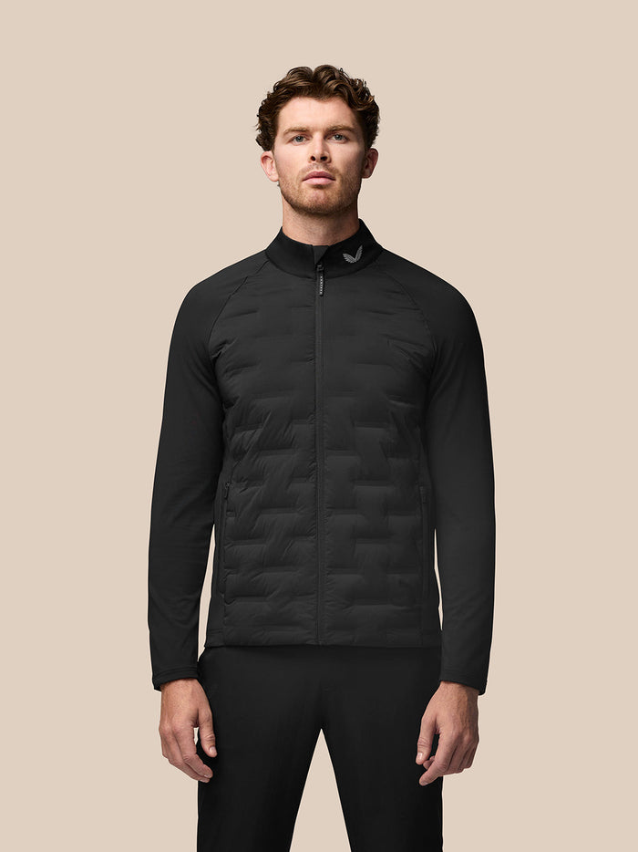 Model wearing black Golf Pinnacle Jacket with quilted front panels and stand collar
