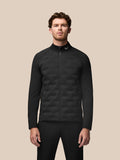 Front view of male model in black Pinnacle Golf Jacket with full zip and stand collar.