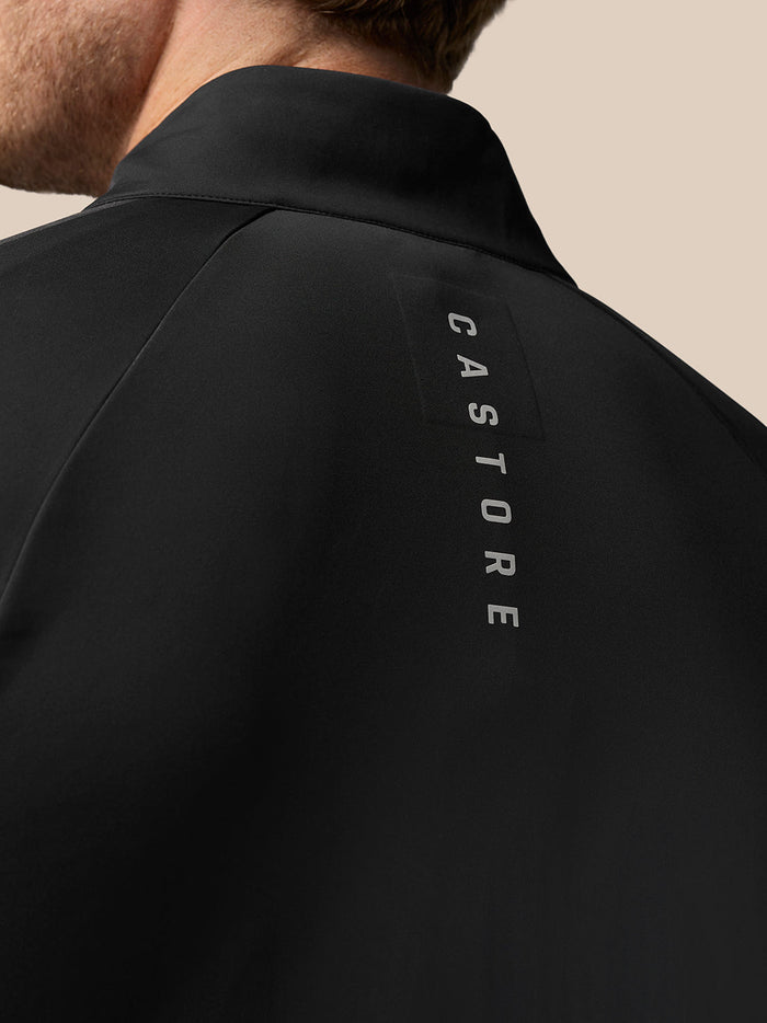 Back view of black Golf Pinnacle Jacket with vertical Castore branding along the shoulder