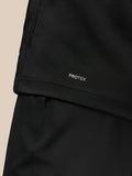 Close up of black Pinnacle Golf Jacket fabric with PROTEK label.
