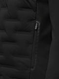 Close-up of black Pinnacle Golf Jacket front showing bonded quilting and a water resistant zip pocket.