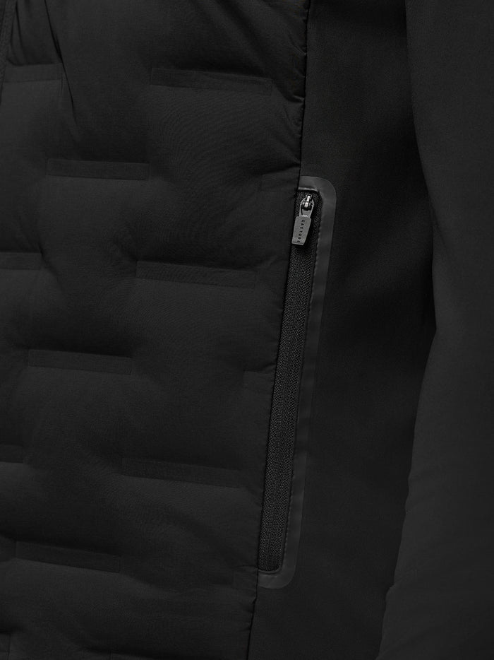 Close up of a zipped side pocket on the black Golf Pinnacle Jacket with Castore zipper pull