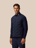 Male model in navy Golf Pinnacle set with short sleeve tee and matching shorts displaying logos