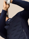 Close-up of navy Pinnacle Jacket noting the zip side pocket with auto lock puller