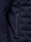 Detail of navy Golf Pinnacle Jacket with quilted front panels and Castore logo on the collar