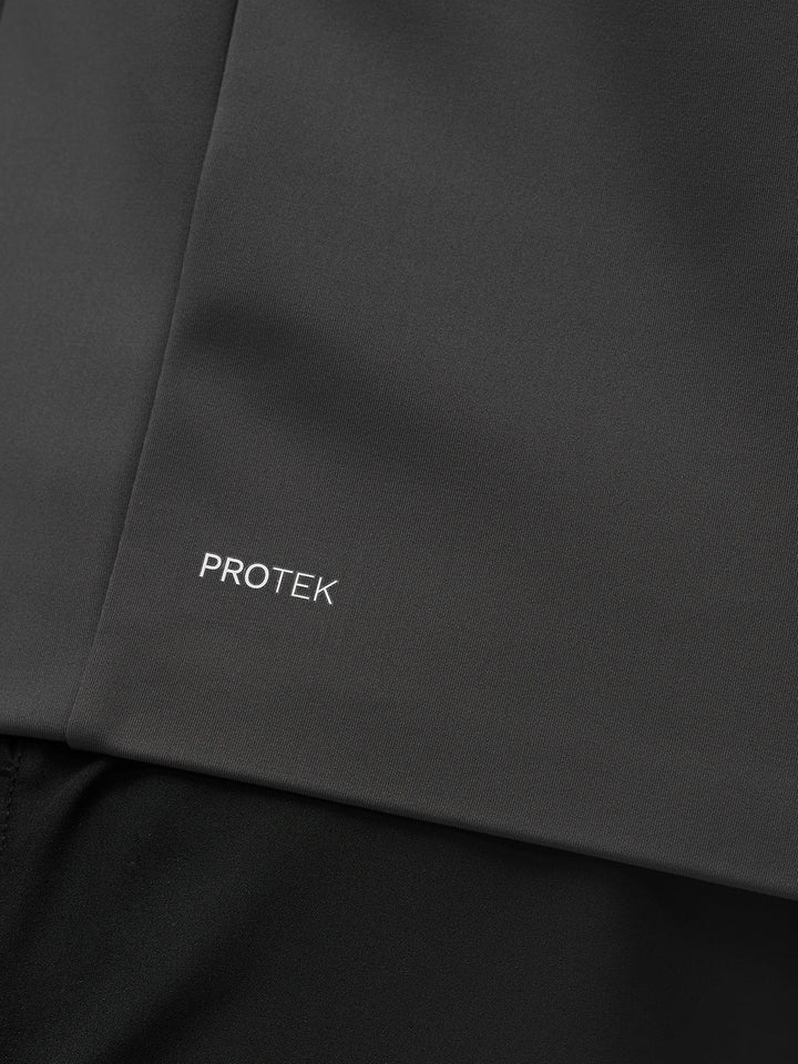 Close up of dark charcoal Protek fabric with the PROTEK branding on the jacket