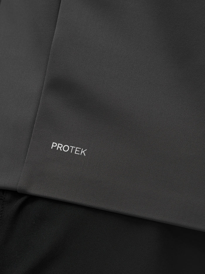 Close up of dark charcoal Protek fabric with the PROTEK branding on the jacket
