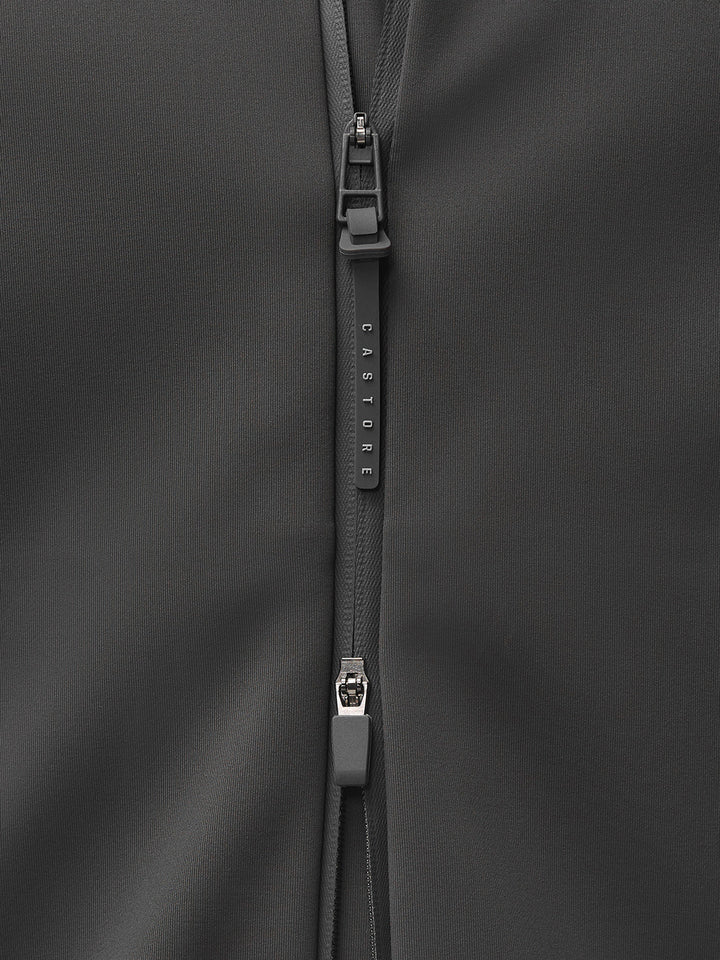 Close-up of a dark gray jacket zipper with a Castore branded pull