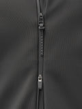Close-up of a dark gray jacket zipper with a Castore branded pull