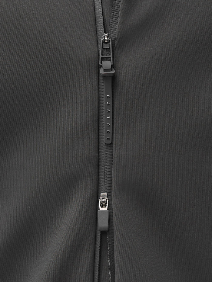 Close-up of a dark gray jacket zipper with a Castore branded pull