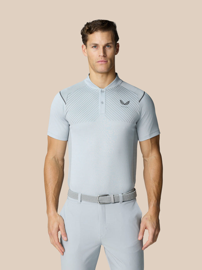 Male model wearing a light grey Pinnacle LVS golf polo with diagonal pattern and chest logo.