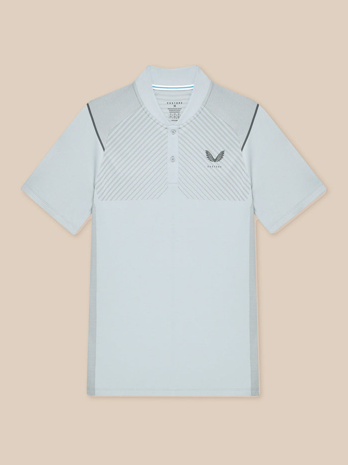 Pinnacle Golf LVS Polo in light grey shown flat with diagonal vented panels and side splits