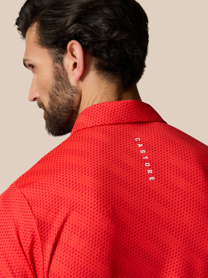 Back view of a red Club Graphic Polo showing a dotted texture and Castore branding along the upper back.