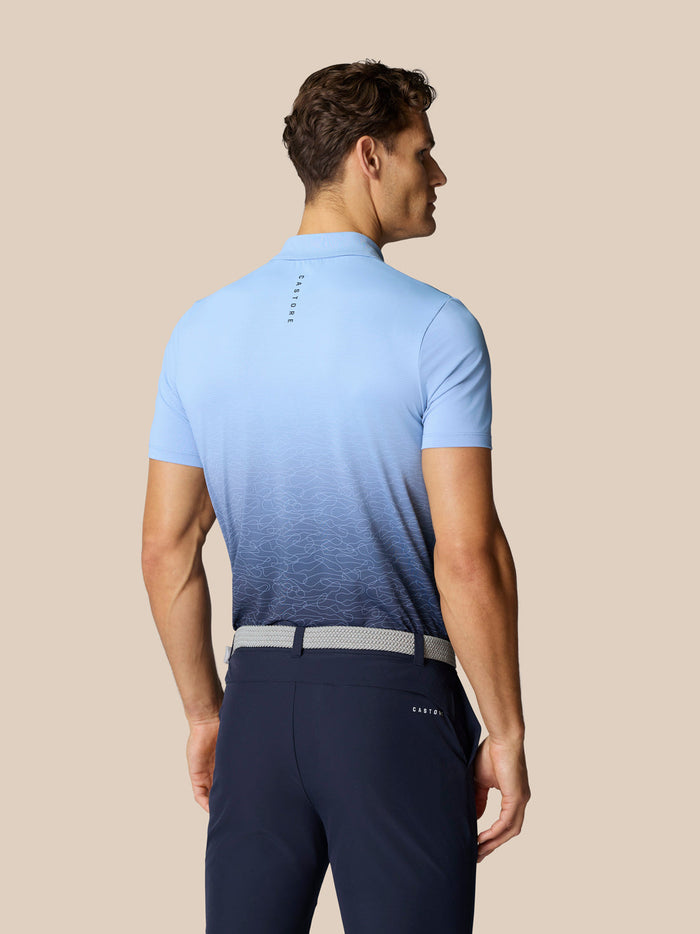 Back view of Club Graphic Polo in light blue fading to navy with a subtle wave pattern