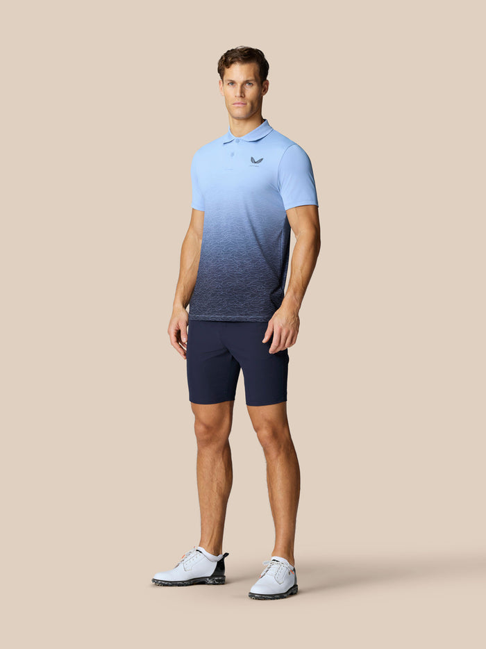 Male model wearing Club Graphic Polo with sky blue gradient and Castore logos on chest and back.