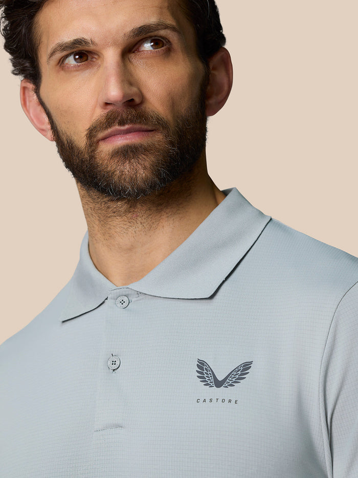 Front view of a man in a light blue Club Graphic Polo with Castore logo on the left chest.
