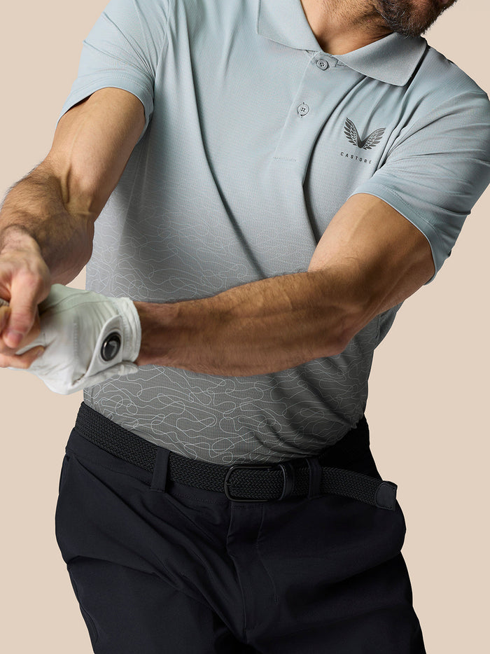 Close-up of a mid grey Club Graphic Polo showing the Castore logo on the left chest and an ombre pattern across the front.
