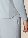 Close-up of Pinnacle LVS 1/4 Zip Top fabric showing textured knit panels and curved hem seam
