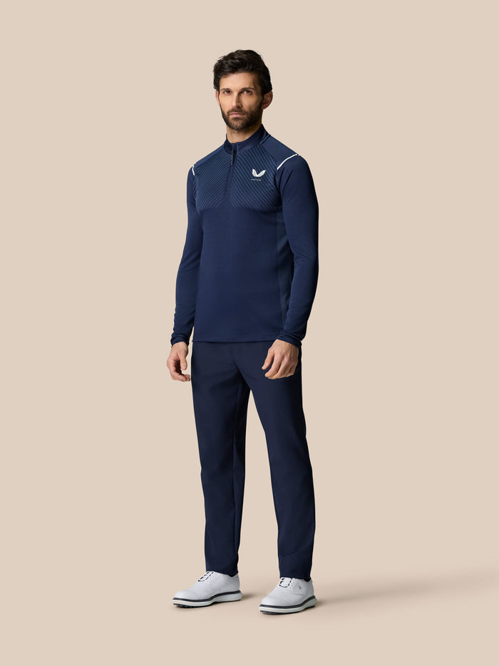 Man in navy LVS Quarter Zip Top with venting panels, zip closure and side split hems for movement.