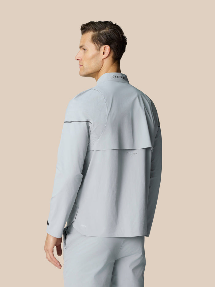 Back view of mid grey Golf Pinnacle LVS Woven Jacket showing vented yoke and collar branding