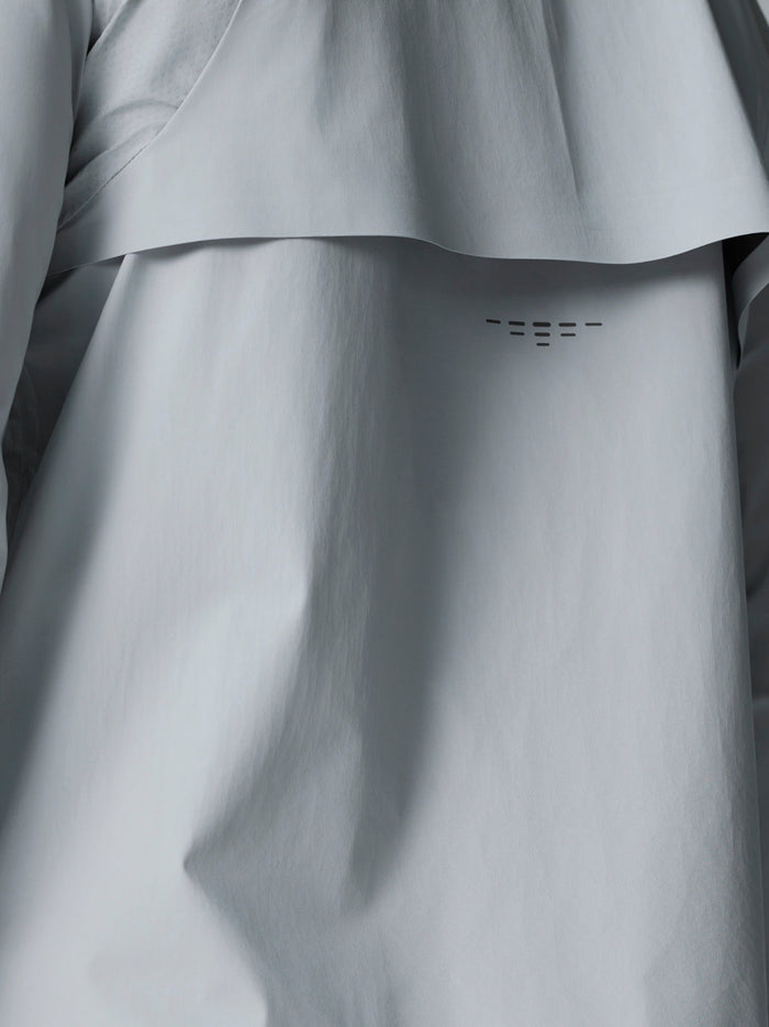 Close up of mid grey Golf Pinnacle LVS Woven Jacket showing back vent panel and curved hem