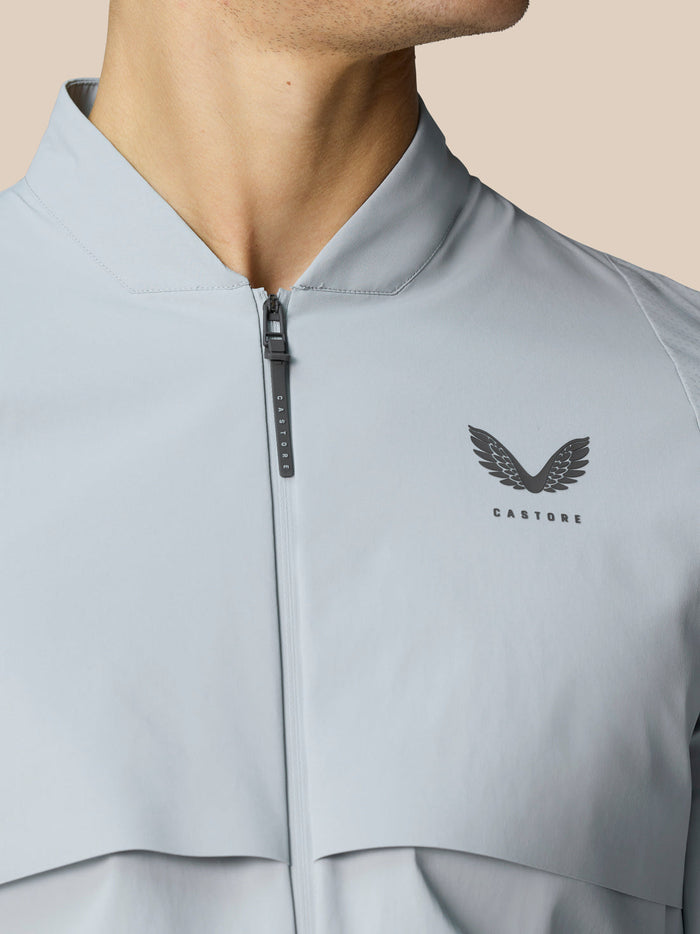 Front close up of Golf Pinnacle LVS Woven Jacket in mid grey with a zip and Castore logo on the chest