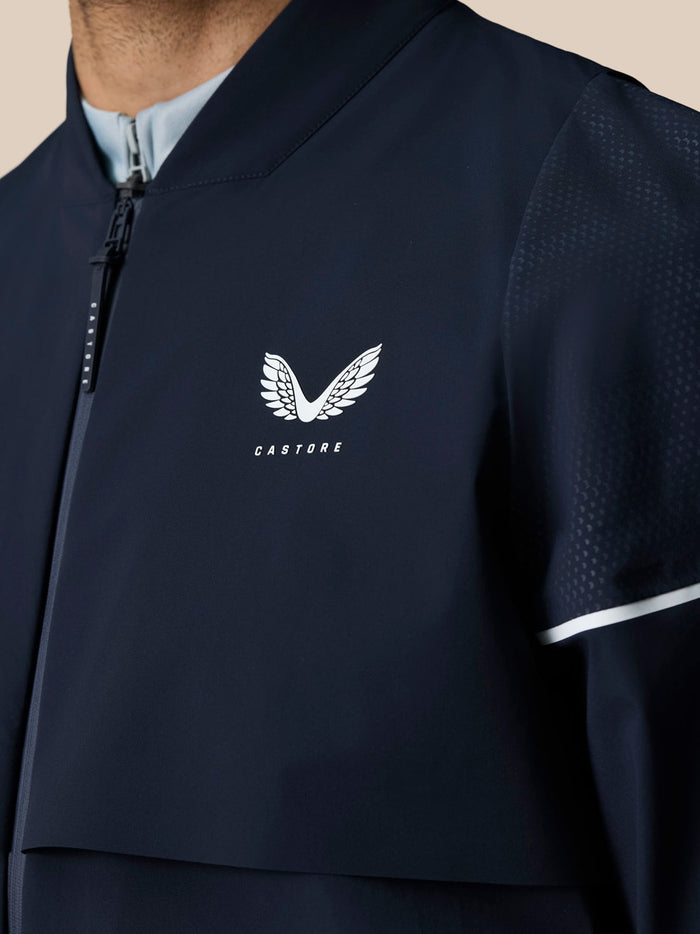 Midnight Navy jacket close up showing CASTORE logo with wing emblem on chest and perforated sleeve detail.