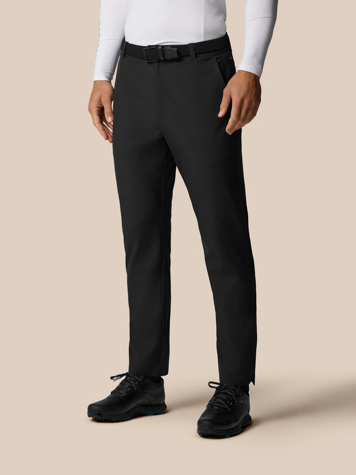 Model wearing black Pinnacle Winter Trousers with belt shown full length for winter golf