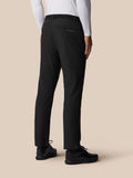 Back view of a person wearing black Golf Pinnacle Winter Trousers with a woven belt and Castore logo on the back pocket.